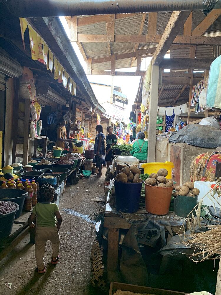 A busy local market with stalls of goods