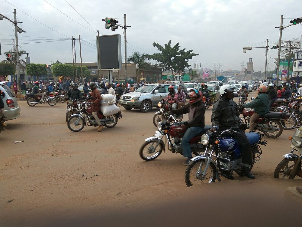 A busy street with cars and motorcycles in East Africa
